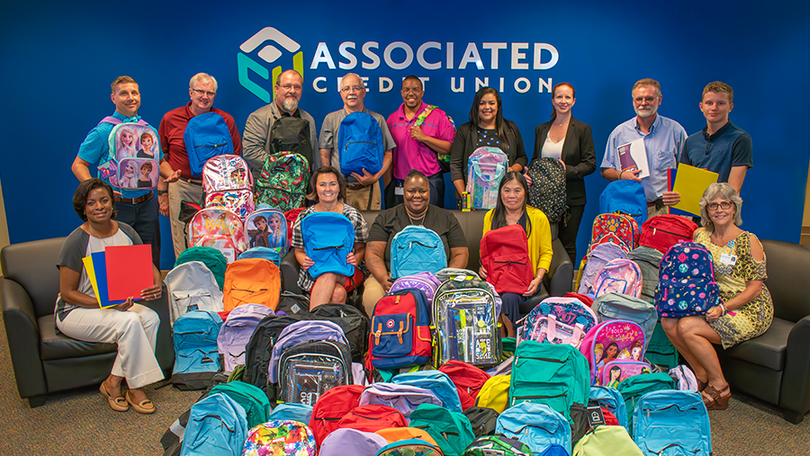 ACU Employees with Donated Backpacks