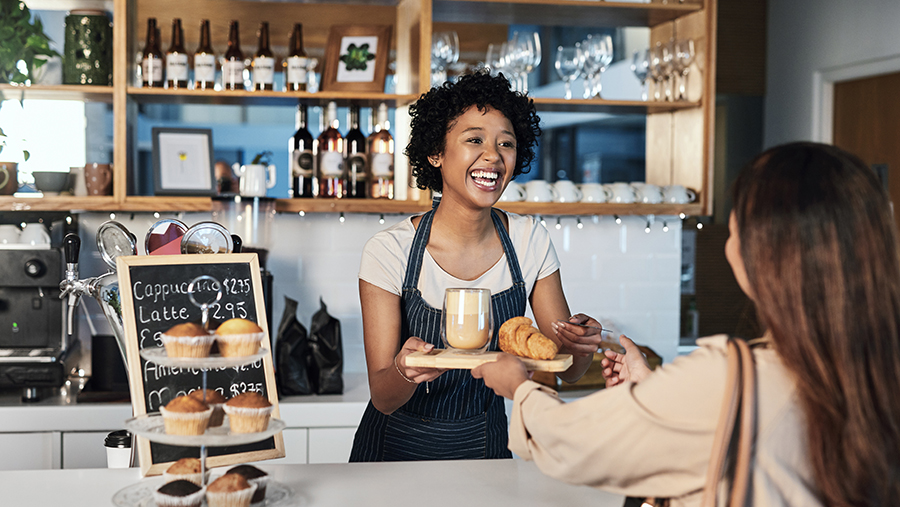 Cafe Employee Giving Order to Customer