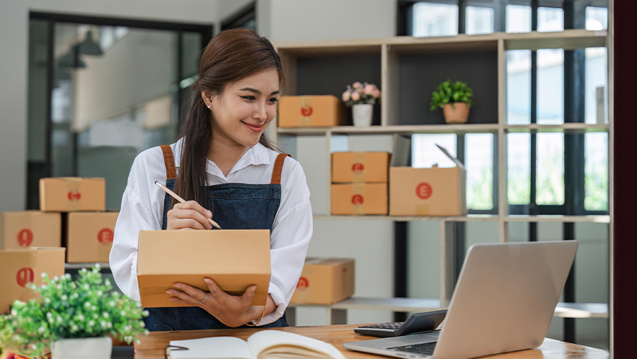 Woman Writing Order On Box