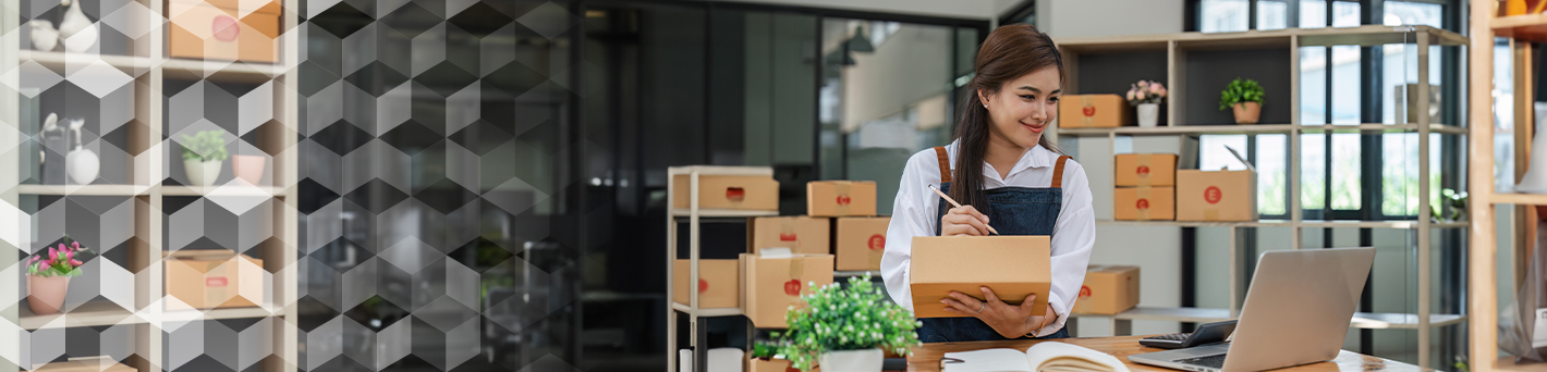 Small Business Owner Writing on Boxes