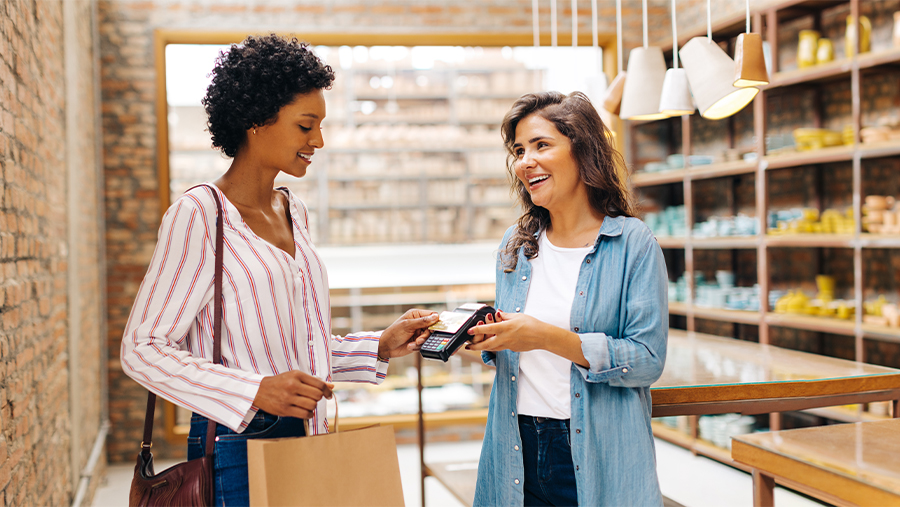 Woman Making Purchase From Pottery Artist