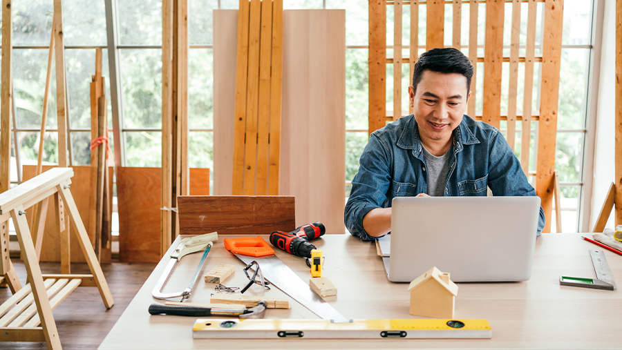 Carpenter On Laptop Using Online Services