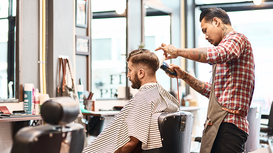 Barber Clipping Customer's Hair