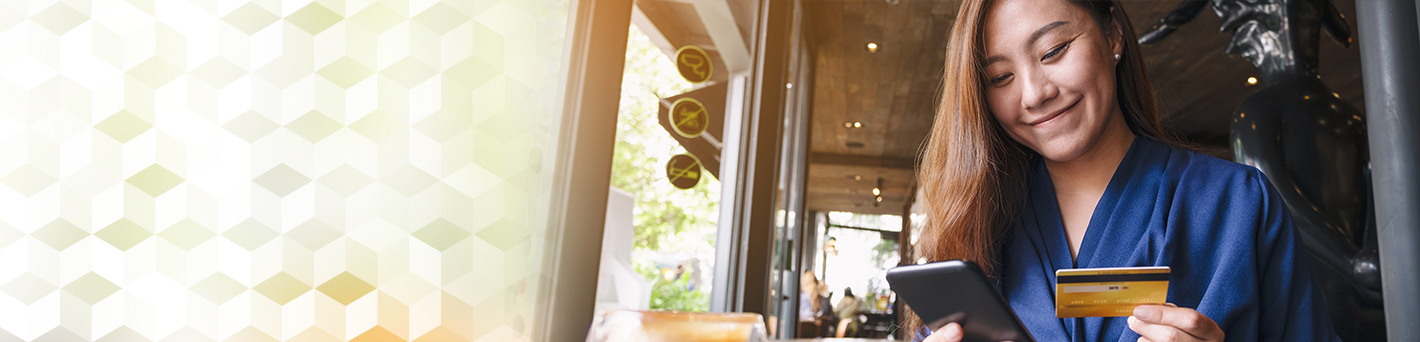 Woman with gift card in a cafe.