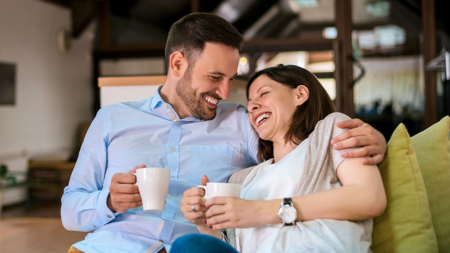 Couple drinking coffee and laughing