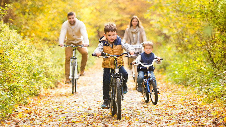 Family riding bikes together on a trail