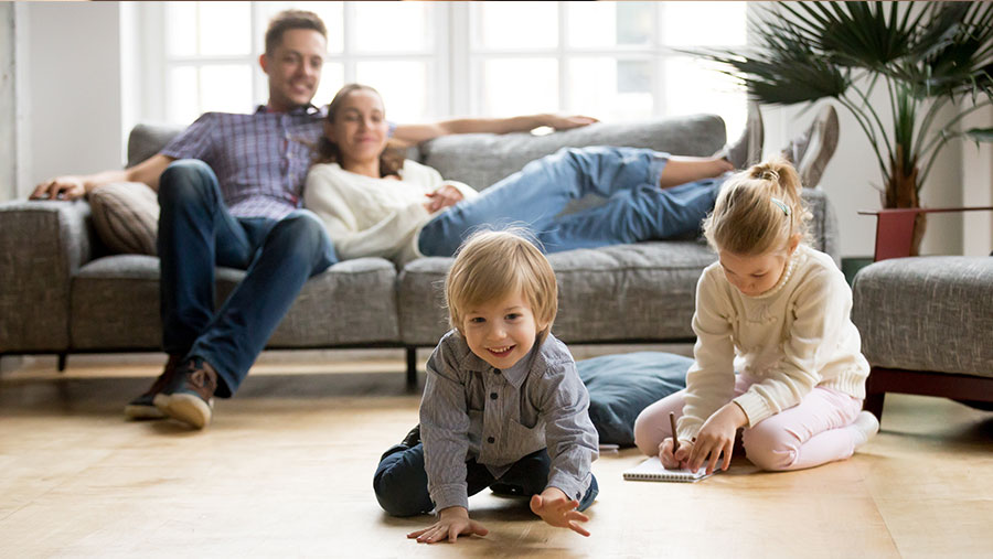 Parents watching children playing at home