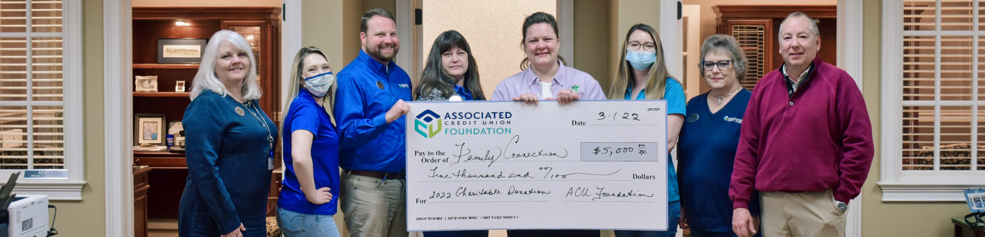 ACU employees donating a $5,000 check to Family Connection