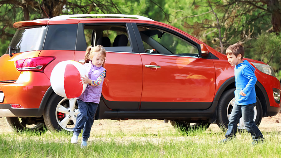 Kids outside playing near vehicle