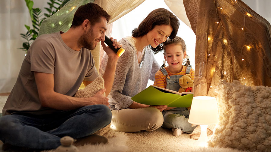 Parents and child reading a book