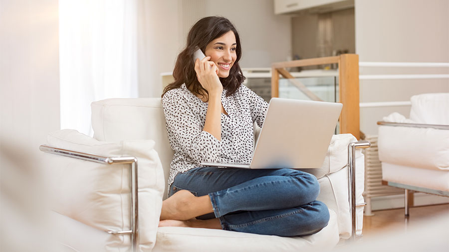 Woman on the phone holding laptop computer