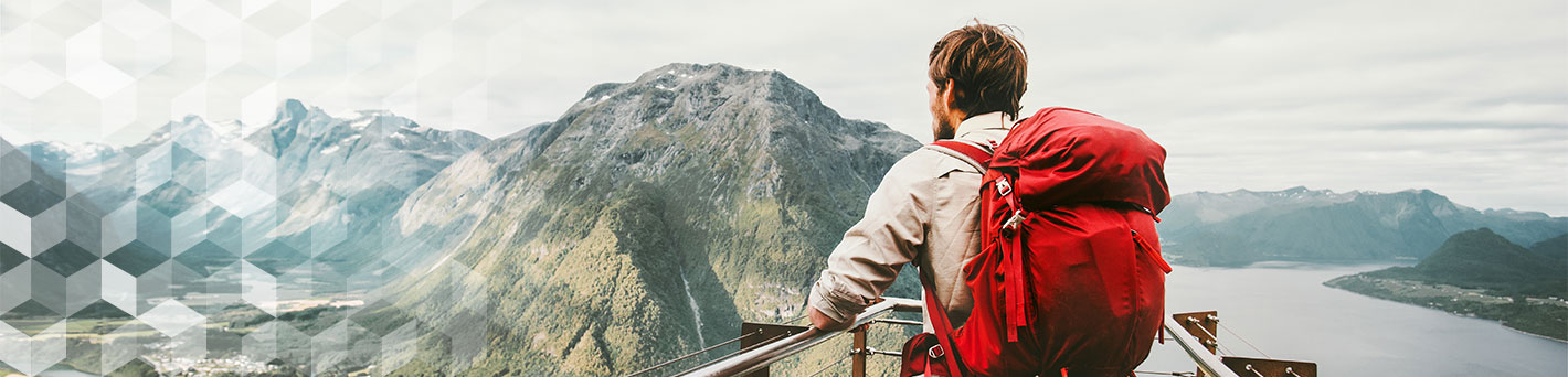 Man hiking looking at mountains.