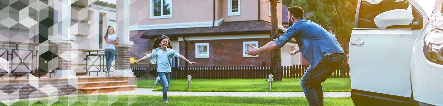 Father and daughter outside of home next to vehicle.