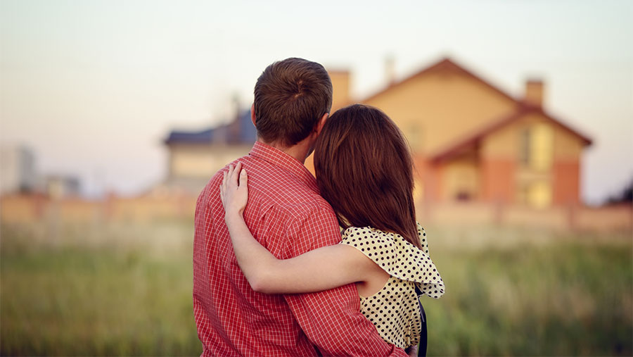 Couple looking at a house in the distance