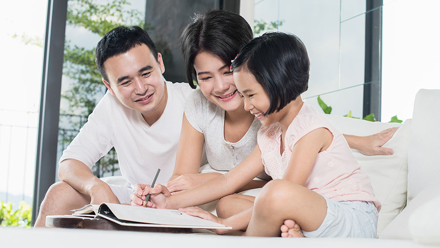 Parents helping daughter with homework