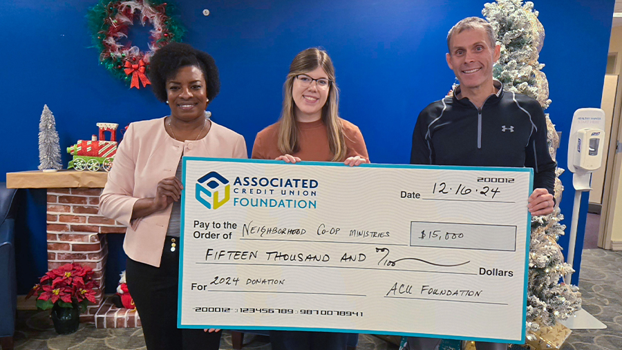 ACU employees with novelty-size donation check