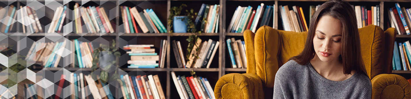 Girl sitting on chair reading a book