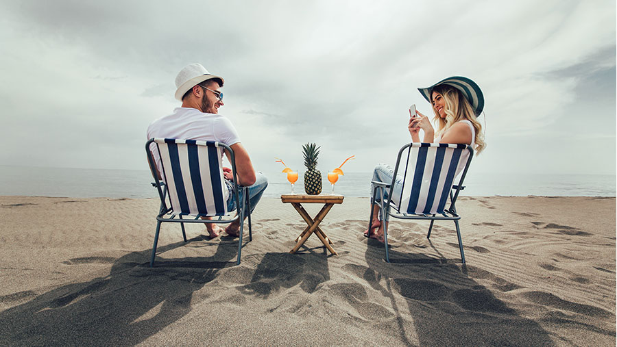 Young couple sitting on the beach