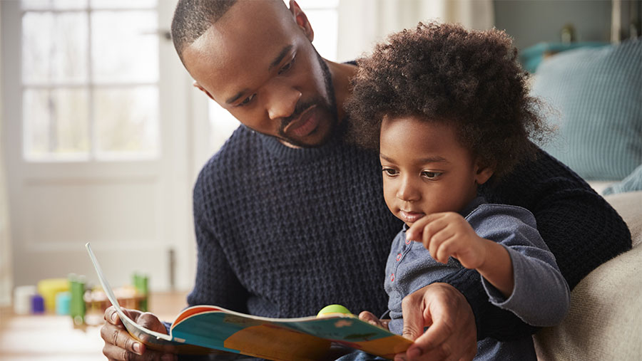 Father and son reading a book