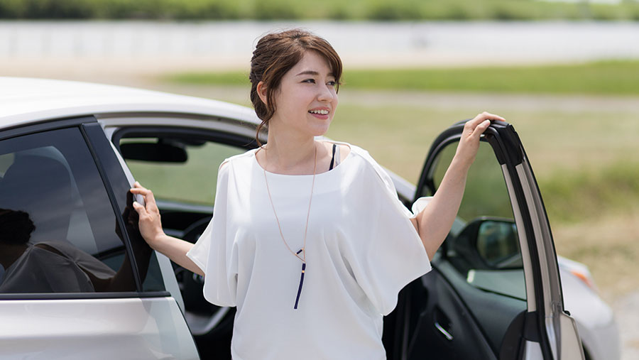 Woman getting out of car