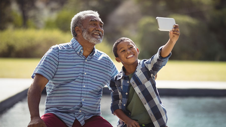 Grandfather and grandson taking selfie